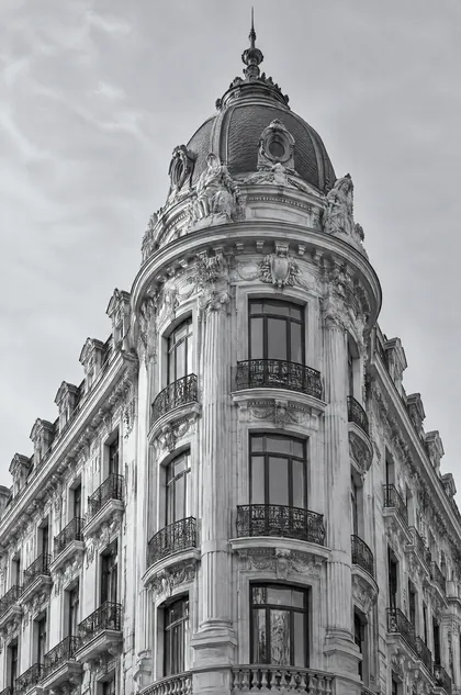 A domed Madrid corner building, in silver tones